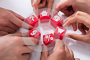 People Holding Red Cubic Blocks With Vivid Icons