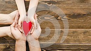 people holding red heart hands with copy space. High quality photo