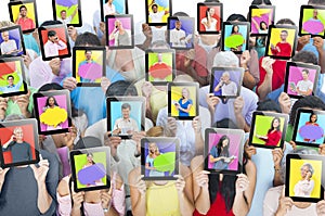 People holding tablets in front of the faces