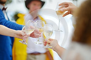 People holding wine glasses at festive event