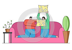 People Home Pastimes Concept. People Are Spending Time At Home. Couple Is Having Pillow Battle On the Sofa