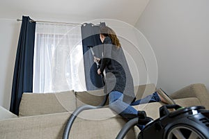 People, housework and housekeeping concept - woman with vacuum c