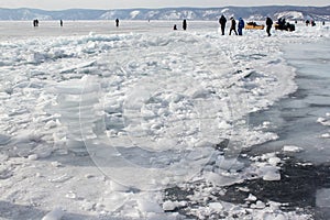 People on ice in the background of the mountains.