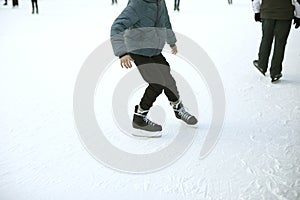 People on ice. Skates on his feet. Entertainment in winter. People skate