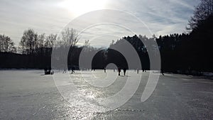 People Iceskating on a frozen lake