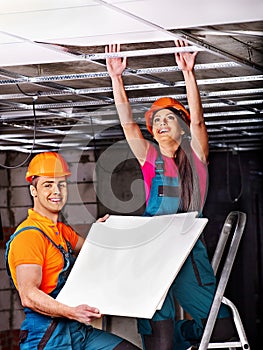 People installing suspended ceiling