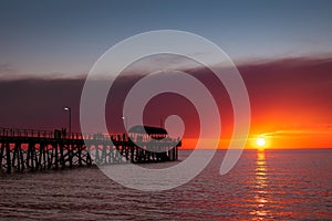 People on jetty at sunset