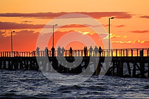 People on Jetty watching Sunset