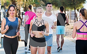 People jogging on city seafront