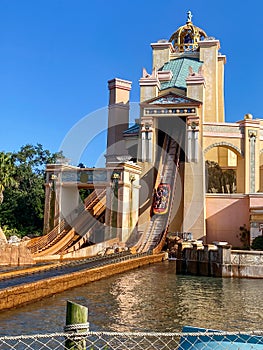 People on the Journey to Atlantis Roller Coaster water ride at SeaWorld speeding around the track and splashing into the water