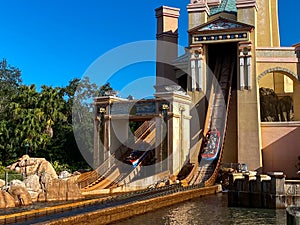 People on the Journey to Atlantis Roller Coaster water ride at SeaWorld speeding around the track and splashing into the water