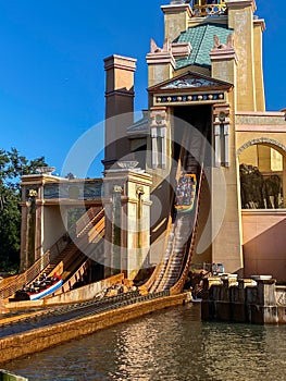 People on the Journey to Atlantis Roller Coaster water ride at SeaWorld speeding around the track and splashing into the water