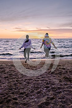 People with jumprope exersise on the beach, couple men and woman exersise together outsied on the beach in the