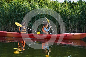 People on kayak outing rafting down the river