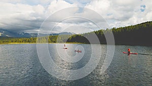 People kayaking on the crystal water lake. Aerial footage