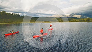 People kayaking on the crystal water lake. Aerial footage