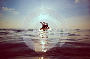 People kayaking at sunset