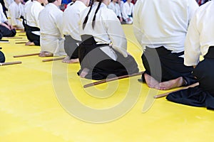 People in kimono on martial arts weapon training seminar