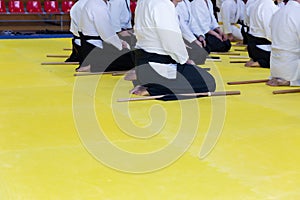 People in kimono on martial arts weapon training seminar