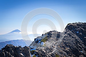 People on Kitadake peak taking rest and looking at Mt.Fuji photo