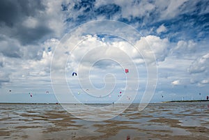 People kite surfing on the beach