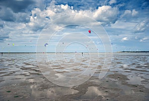 People kite surfing on the beach