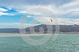 People kite surfing in Langebaan seaside town in South Africa photo
