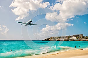 People and landing plane at st.Maarten. Maho beach