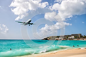 People and landing plane at st.Maarten. Maho beach