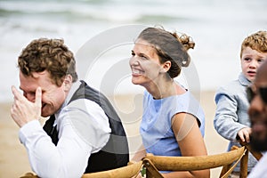 People laughing at a beach wedding