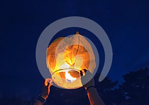 People is launching sky lantern to the sky