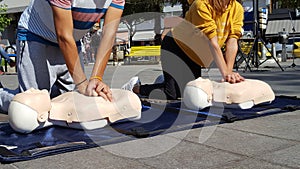 People learning how make first aid heart compressions