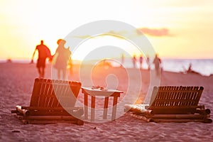 People leaving beach at sunset