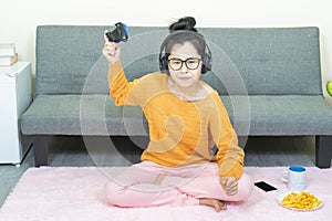 People and leisure concept -Angry asian young woman with gamepad playing video games on console and lose, resting on weekends with