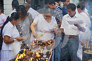 People light candles at the Buddhist temple during Vesak religious celebration in Colombo, Sri Lanka.