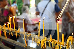 People lighting incense to pray in buddhism
