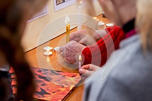 People lit candles and held in their hands in honor of the feast