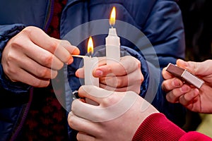 People lit candles and held in their hands in honor of the feast