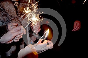 People lit the sparklers under the chiming clock for the new year photo