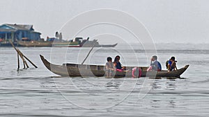 People in long boat, Tonle Sap, Cambodia