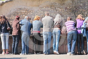 People look at rock wall in zoo