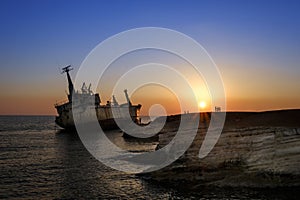 People look at a stranded ship