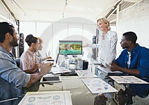 People looking at a computer with e-learning information in the screen