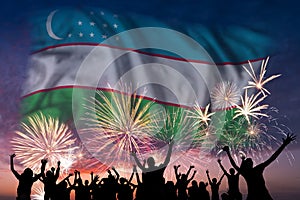 People are looking on fireworks and flag of Uzbekistan