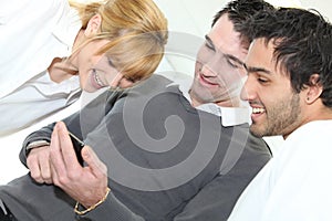 People looking at mobile telephone