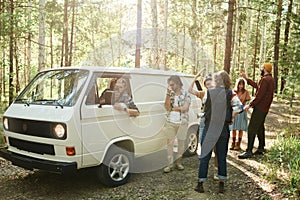 People looking for a phone connection in the forest