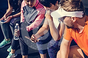 People looking at smart phones at fitness gym