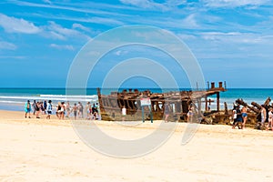 People at the Maheno shipwreck on 75 mile beach, one of the most popular landmarks on Fraser Island, Fraser Coast, Queensland, Aus