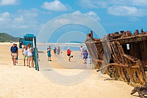 People at the Maheno shipwreck on 75 mile beach, one of the most popular landmarks on Fraser Island, Fraser Coast, Queensland, Aus