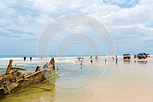 People at the Maheno shipwreck on 75 mile beach, one of the most popular landmarks on Fraser Island, Fraser Coast, Queensland, Aus